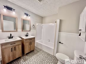 Decatur house for rent - A bathroom with two sinks and a bathtub.