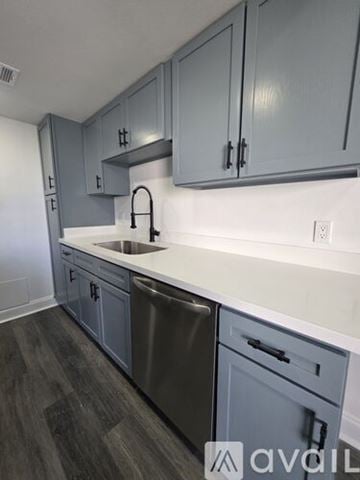Slidell apartment for rent - A kitchen with wooden cabinets and appliances.