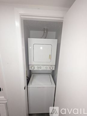 Slidell apartment for rent - A small white laundry machine sits in a narrow space.