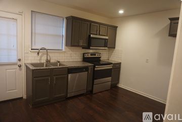 Montgomery house for rent - A kitchen with dark wood floors and white subway tiles.