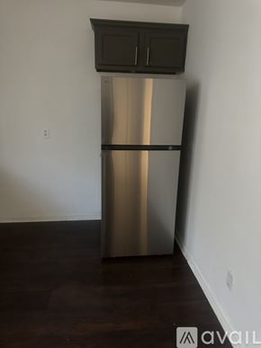 Montgomery house for rent - A stainless steel refrigerator with black handles and a black top sits in a room with a wooden floor.