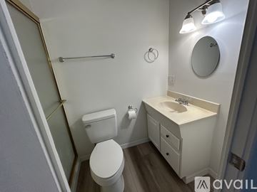 Sarasota apartment for rent - A living room with a brown couch and a ceiling fan.