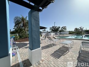 Sarasota apartment for rent - A pool area with a hot tub and lounge chairs.