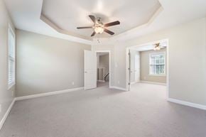 Sneads Ferry house for rent - A spacious room with a ceiling fan and a doorway leading to another room.