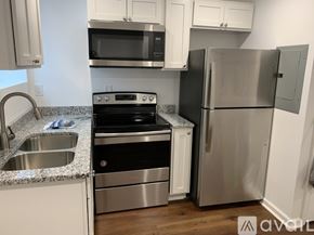Salisbury apartment for rent - A kitchen with a stainless steel refrigerator, microwave, oven, and sink.