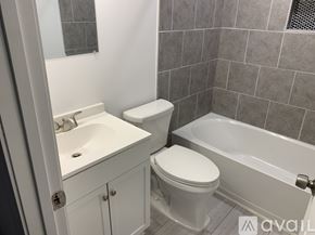 Salisbury apartment for rent - A bathroom with a toilet, sink, and bathtub.