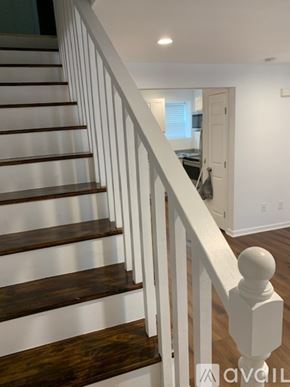 Salisbury apartment for rent - A room with wooden floors and white walls.