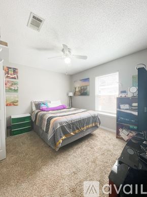 Navarre house for rent - A bedroom with a bed, dresser, and ceiling fan.
