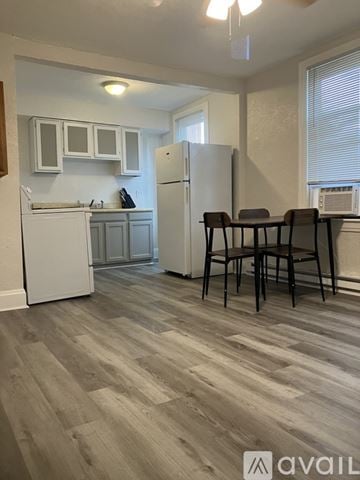 Greensburg apartment for rent - A kitchen with a white refrigerator and wooden flooring.