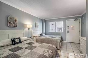 Myrtle Beach condo for rent - A bedroom with two beds and a dresser.