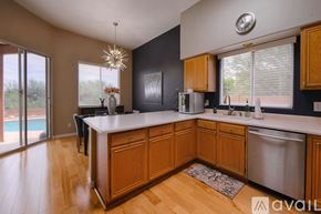 Oro Valley house for rent - A kitchen with wooden cabinets and a large island.