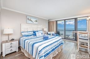 Myrtle Beach condo for rent - A bedroom with a large bed and a view of the ocean.