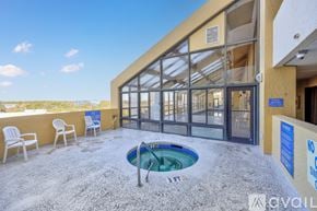 Myrtle Beach condo for rent - A hot tub is in the middle of a patio with chairs around it.