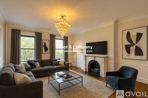 Boston apartment for rent - A room with wooden floors and a fireplace is available for rent.