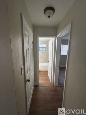 Belle Glade apartment for rent - A hallway with white walls and wooden floors.