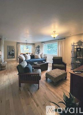 Mount Shasta apartment for rent - A house with blue garage doors is surrounded by trees.