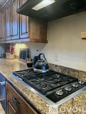 Mount Shasta apartment for rent - A kitchen with wooden cabinets and a black mat on the floor.