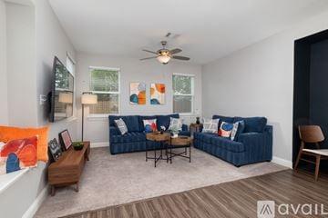 Lewisville house for rent - A living room with a blue couch and a wooden coffee table.