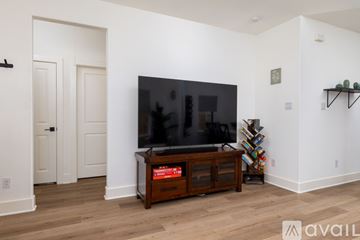 Fort Worth house for rent - A living room with a television and a cabinet.