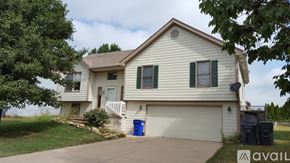 Olathe house for rent - A house with a blue trash can in front of it.