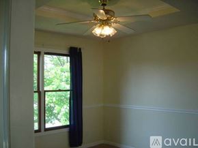 Olathe house for rent - A room with a ceiling fan and a window.
