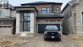 Brant (Paris) house for rent - A black truck is parked in front of a modern house.