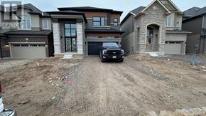 Brant (Paris) house for rent - A dirt lot with a black truck and houses in the background.