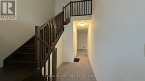 Brant (Paris) house for rent - A hallway with a staircase and a door at the end.