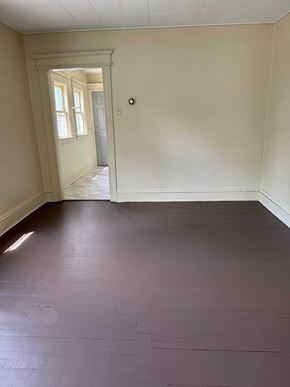 Syracuse apartment for rent - A room with a wooden floor and a white door.