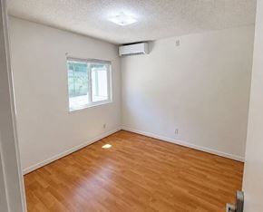 Monterey Park apartment for rent - A room with a window and wooden flooring.
