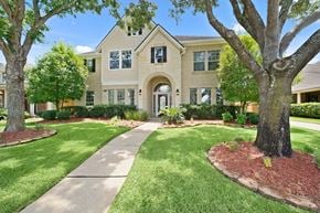 Houston house for rent - A house with a tree in front of it.