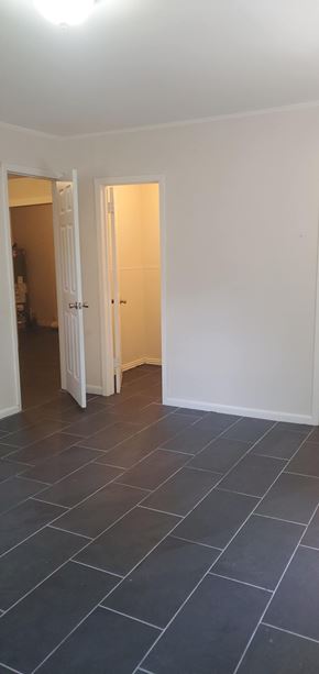 Hattiesburg house for rent - A room with a white door and a black floor.