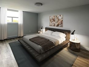 Oshawa apartment for rent - A bedroom with a large bed and a painting on the wall.