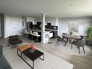 Oshawa apartment for rent - A modern kitchen and dining area with a black coffee table in the center.