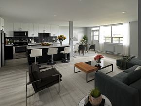 Oshawa apartment for rent - A modern living room with a kitchen in the background.
