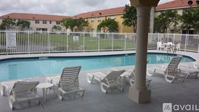Homestead apartment for rent - A pool with chairs around it and a sign on the fence.