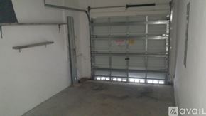 Homestead apartment for rent - A large garage door is open to a spacious garage.
