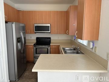 Homestead apartment for rent - A kitchen with wooden cabinets and a white fridge.