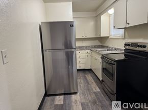 Salem apartment for rent - A kitchen with a stainless steel refrigerator and black stove.
