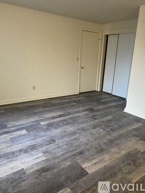 Salem apartment for rent - A room with a grey wood floor and white walls.