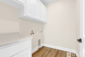 Sherman house for rent - A kitchen with white cabinets and a white counter top.