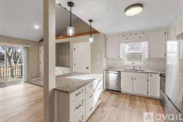 Hudson apartment for rent - A kitchen with white cabinets and a granite countertop.