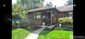 Vestal house for rent - A house with a brown roof and a green lawn.