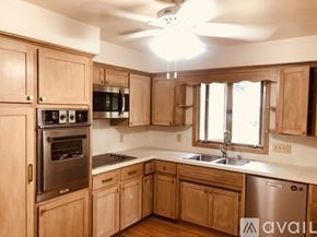 Vestal house for rent - A kitchen with wooden cabinets and a stainless steel dishwasher.