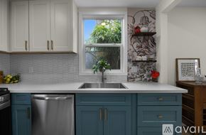 Portland house for rent - A kitchen with blue cabinets and a white countertop.