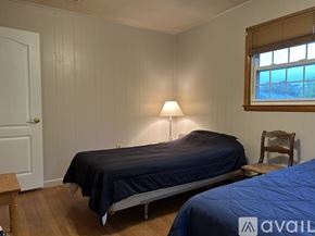 Bel Air house for rent - A bedroom with a bed, a chair, and a window.