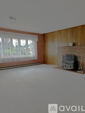 Bel Air house for rent - A living room with a fireplace and a window with blinds.