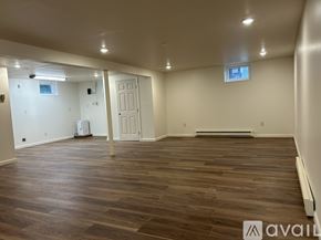 Bel Air house for rent - A spacious room with wooden flooring and white walls.