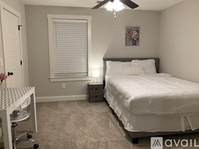 Oxford house for rent - A bedroom with a bed, desk, and chair.