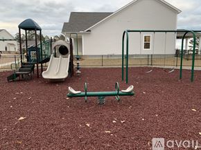 Oxford house for rent - A playground with a slide, swings, and a seesaw.